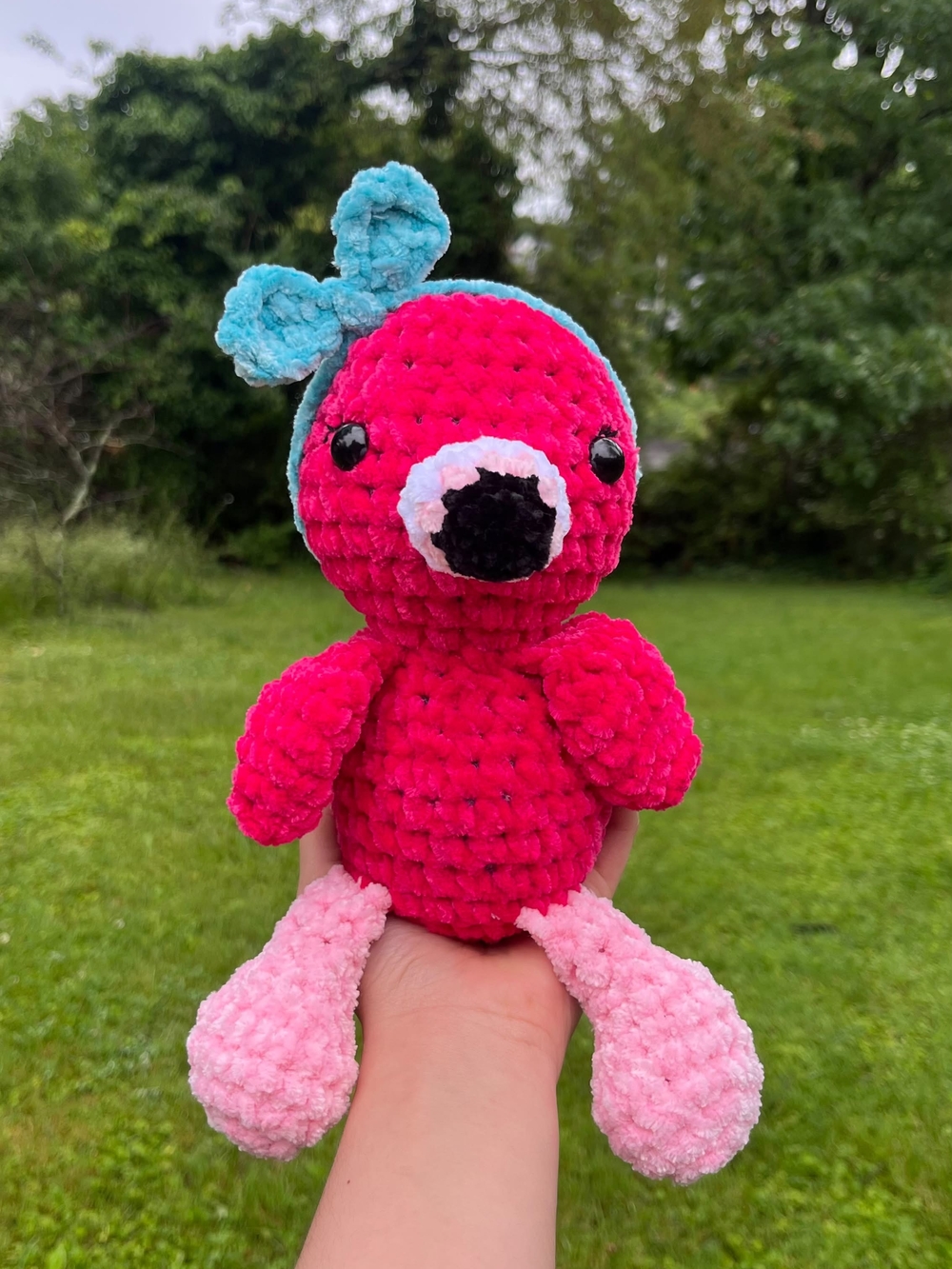 crochet handmade pink flamingo plushie with a teal headband